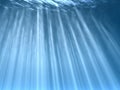 Solar beams and blue water Royalty Free Stock Photo