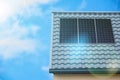 Solar cell panel on metal roof of house. Photovoltaic solar modules with the rays of sun. Alternative source of electricity, power