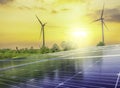 Solar cell panels and wind turbines in sunset sky for alternatively power generator source Royalty Free Stock Photo