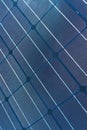 A solar cell pattern close up. Green energy and sustainable electricity resource concept. Solar panels blue background.