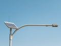 Solar cell street lamp with long arm standing against blue sky day. Royalty Free Stock Photo