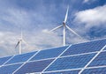 Solar cells with wind turbines generating electricity in hybrid power plant systems station on blue sky background