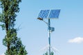 Solar device with street lamp on background of blue sky. Street light powered by solar panel with battery included. Alternative Royalty Free Stock Photo