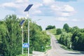 Solar device with street lamp on background of blue sky. Street light powered by solar panel with battery included. Alternative Royalty Free Stock Photo