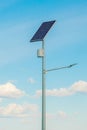 Solar device with street lamp on background of blue sky. Street light powered by solar panel with battery included. Alternative Royalty Free Stock Photo