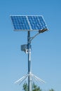 Solar device with street lamp on background of blue sky. Street light powered by solar panel with battery included. Alternative Royalty Free Stock Photo