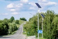 Solar device with street lamp on background of blue sky. Street light powered by solar panel with battery included. Alternative Royalty Free Stock Photo