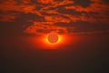 Solar eclipse on clear red orange sky sunset in the evening Royalty Free Stock Photo