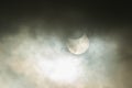 Solar eclipse on a cloudy day. Royalty Free Stock Photo