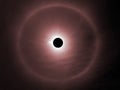 solar eclipse and rainbow ring around in dark red sky Royalty Free Stock Photo