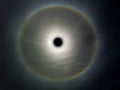 solar eclipse and rainbow ring around in dark sky Royalty Free Stock Photo