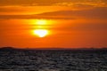 Solar eclipse at sunset across the sky above the sea Royalty Free Stock Photo