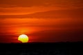 Solar eclipse at sunset across the sky above the sea Royalty Free Stock Photo