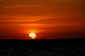 Solar eclipse at sunset across the sky above the sea Royalty Free Stock Photo