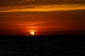 Solar eclipse at sunset across the sky above the sea Royalty Free Stock Photo