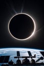 A solar eclipse viewed from space, with the moon completely obscuring the sun, creating a striking halo effect Royalty Free Stock Photo
