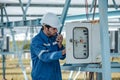 Solar electric installer and practitioner inspect electrical systems for appropriate wiring, polarity, grounding, and termination Royalty Free Stock Photo