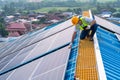 Solar energy, Asian engineering working on roof at solar power station, operation and maintenance in solar power plant