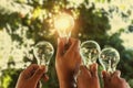 solar energy concept hand group holding light bulb Royalty Free Stock Photo