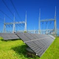 Solar energy panels in the background high voltage power substation.