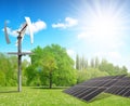 Solar energy panels with wind turbine in spring landscape. Royalty Free Stock Photo