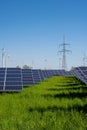 Solar energy plant with power lines and wind turbines Royalty Free Stock Photo