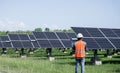 The solar farm(solar panel) with engineers check the operation of the system.