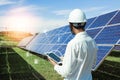 The solar farmsolar panel with engineers is checking the operation of the system by laptop, Alternative energy to conserve the Royalty Free Stock Photo