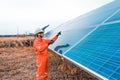 The solar farmsolar panel with engineers is checking the operation of the system by laptop, Alternative energy to conserve the Royalty Free Stock Photo