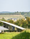 Solar Farm panels,and rural residential buildings in the near distance, the Cotswolds, Gloucestershire,England,United Kingdom