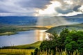 Solar flare and sun rays over Maloti Drakensberg mountains and bell park dam