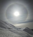 Solar halo in cloudy sky.