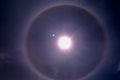 Solar halo is an optical phenomenon produced by light interacting with ice crystals suspended in the atmosphere. Royalty Free Stock Photo