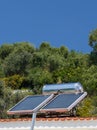 Solar heater green energy, olive trees forest , blue sky