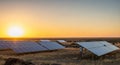 Solar Panel Array in a Dry Landscape During a Golden Sunset solar panels solar energy Royalty Free Stock Photo