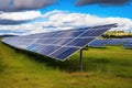 solar panel array in a sunny field, with greener pastures in the background Royalty Free Stock Photo