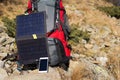 The solar panel attached to the tent. The man sitting next to mobile phone charges from the sun. Royalty Free Stock Photo