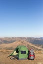 The solar panel attached to the tent. The man sitting next to mobile phone charges from the sun. Royalty Free Stock Photo