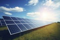 Solar panel on blue sky background. Panels installed in straight long rows. Green grass and cloudy sky Royalty Free Stock Photo