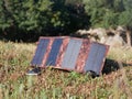 The solar panel charges the smartphone in the grass