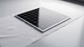 A solar panel with a grid pattern of photovoltaic cells on a sleek white Royalty Free Stock Photo