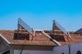 Solar panels on red tiled roof of apartment building Royalty Free Stock Photo