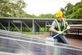 Solar panel installers use brushes to clean dust from solar panels to produce and sell electricity. Royalty Free Stock Photo