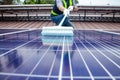 Solar panel installers use brushes to clean dust