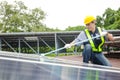 Solar panel installers use brushes to clean dust from solar panels