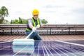 Solar panel installers use brushes to clean dust from solar panels to produce and sell electricity. Royalty Free Stock Photo