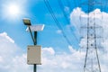 Solar panel lamp with high voltage electricity tower on blue sky background for sustainable energy Royalty Free Stock Photo