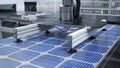 Solar panel placed on conveyor belt, operated by high tech robot arm, render Royalty Free Stock Photo