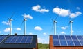 Solar panel on the roof of the house in the background wind turbines and blue sky. Royalty Free Stock Photo