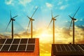 Solar panel on the roof of the house in the background wind turbines at sunset. Royalty Free Stock Photo